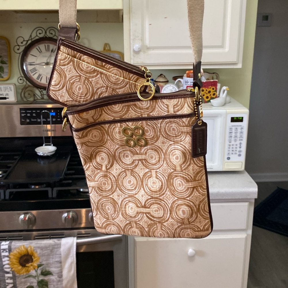 A tan and brown Coach crossbody bag and matching card wallet